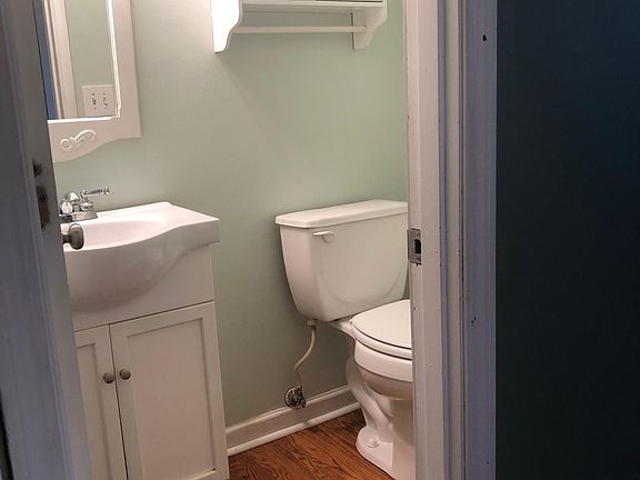 Half bathroom on first floor, just off of the garage and kitchen