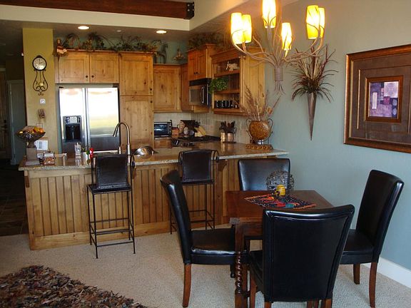 Beautiful custom furniture and lighting in dining area & kit