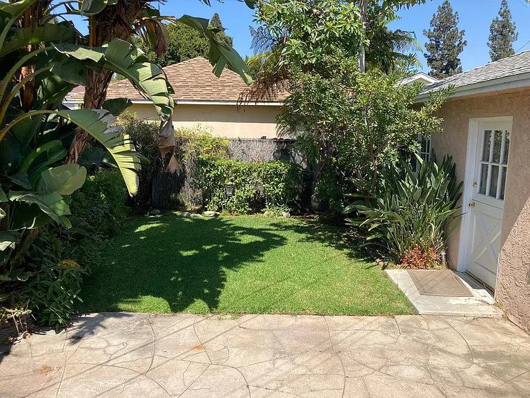 Backyard from bedroom 2. Door to garage office - previous tenant A