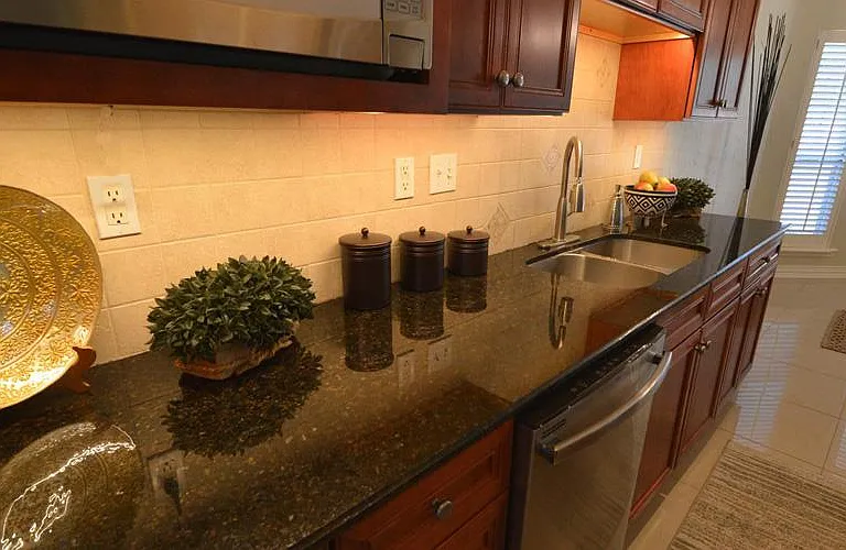 Granite counter tops with stainless fixtures and under cabinet lighting