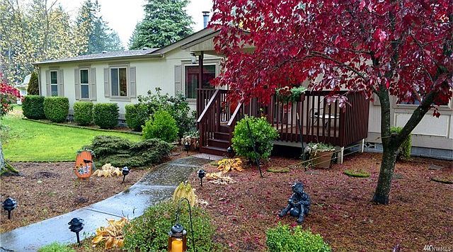 An absolutely lovely setting! With blacktop circular driveway and detached 2 car garage.