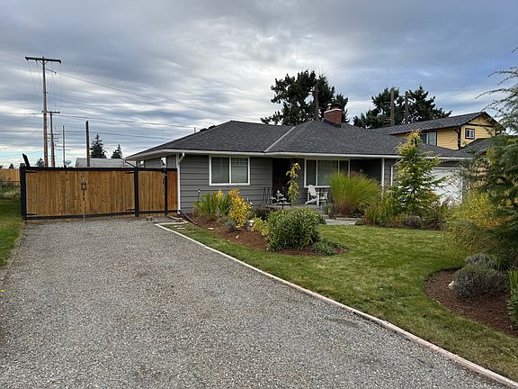 Gravel driveway that extends all the way to the back part of the property.