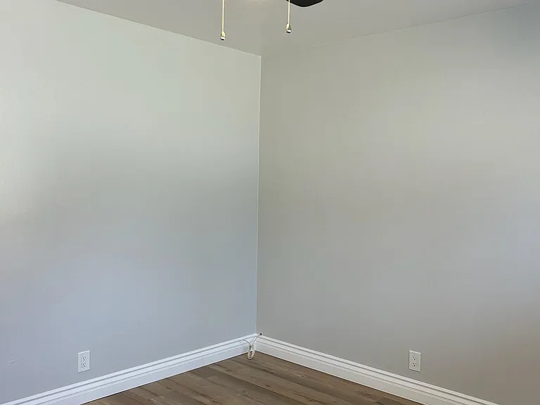 Inside bedroom - brand new designer ceiling lamp/fan, laminate floors, wood molding and specialty paint.