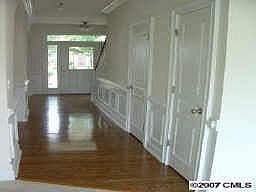 entry hallway with hardwoods and picture molding