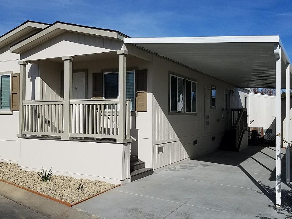 Streetside showing carport with new concrete driveway