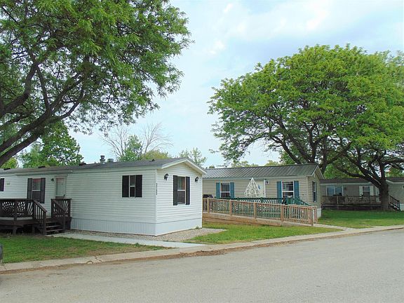 Front of home parking for two cars with beautiful landscaping