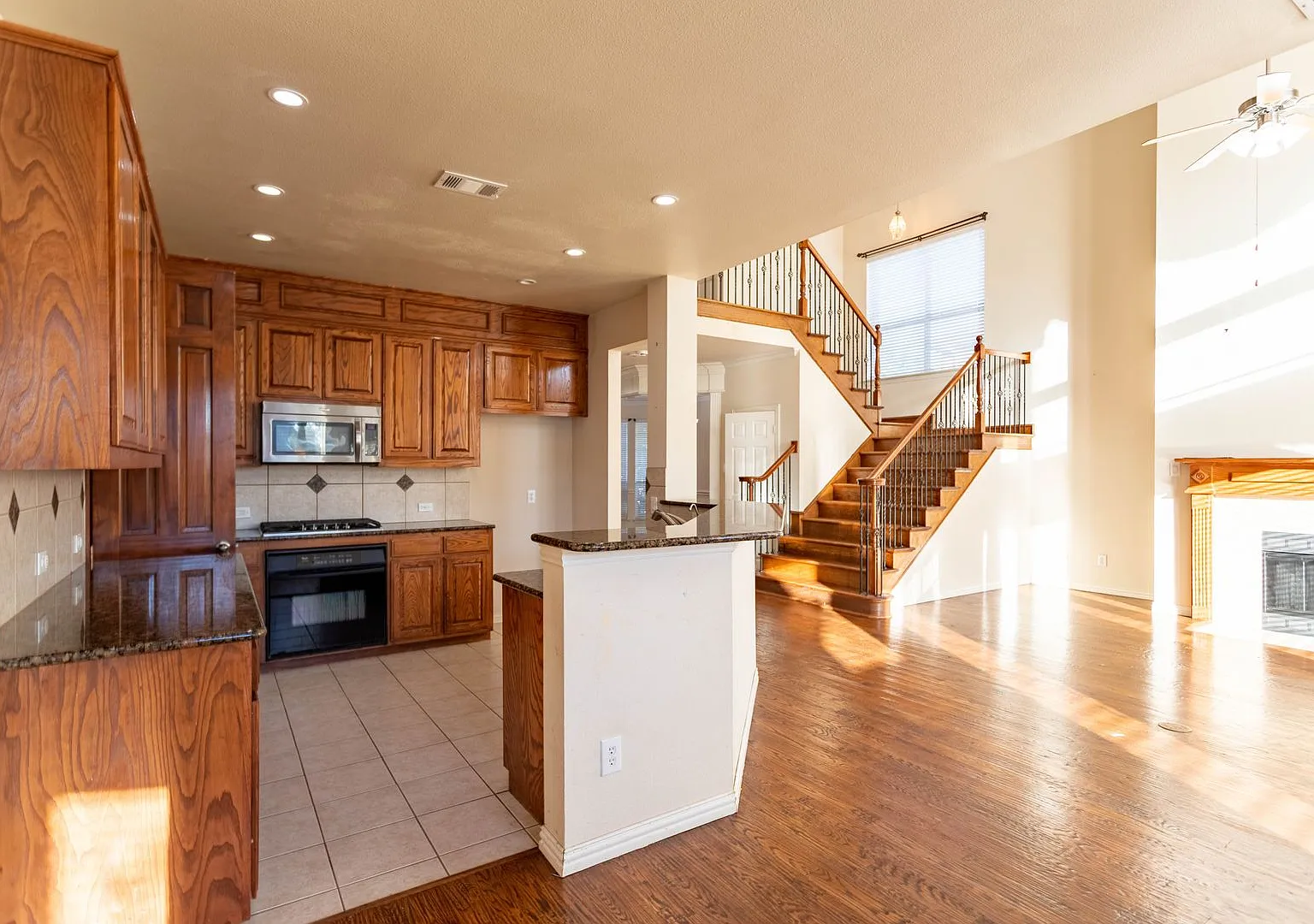 Well kitchen featuring granite countertops, a large island. — Photo 4