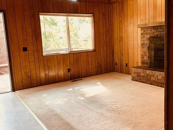 Living room with high beam ceilings and fireplace