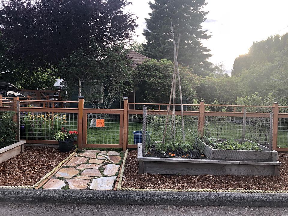 Front yard gate and garden beds from street.