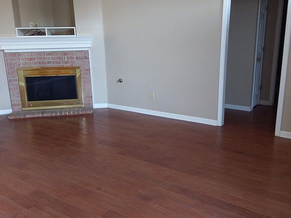 Living room with view of hallway leading to bedrooms.