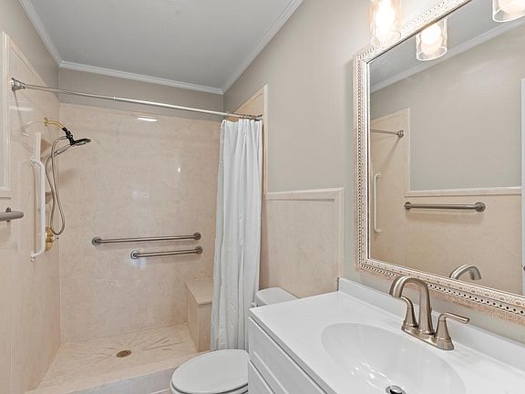 Full bathroom with new mirror, vanity, toilet, lighting