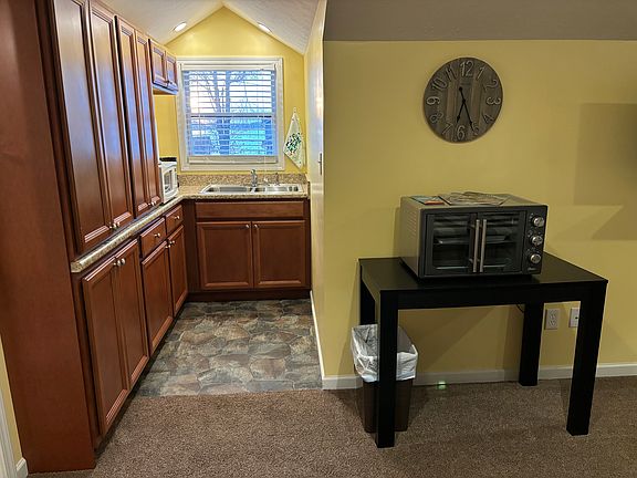 Sink, microwave, toaster/convection oven, cabinets, and window with beautiful lake view