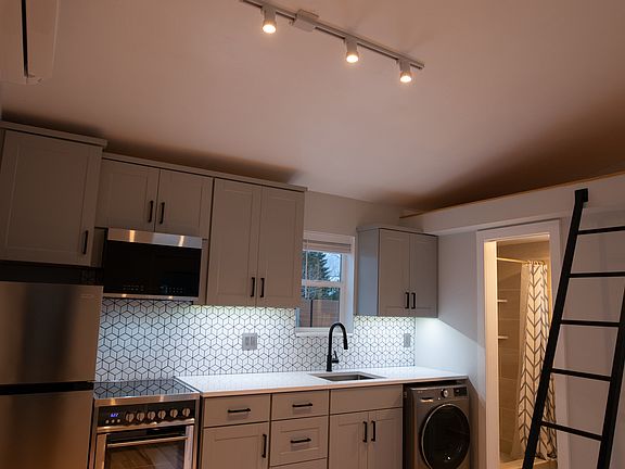 Main kitchen area with track lighting, mini-split heating and cooling, undermounted task lighting, and dimmable switches.