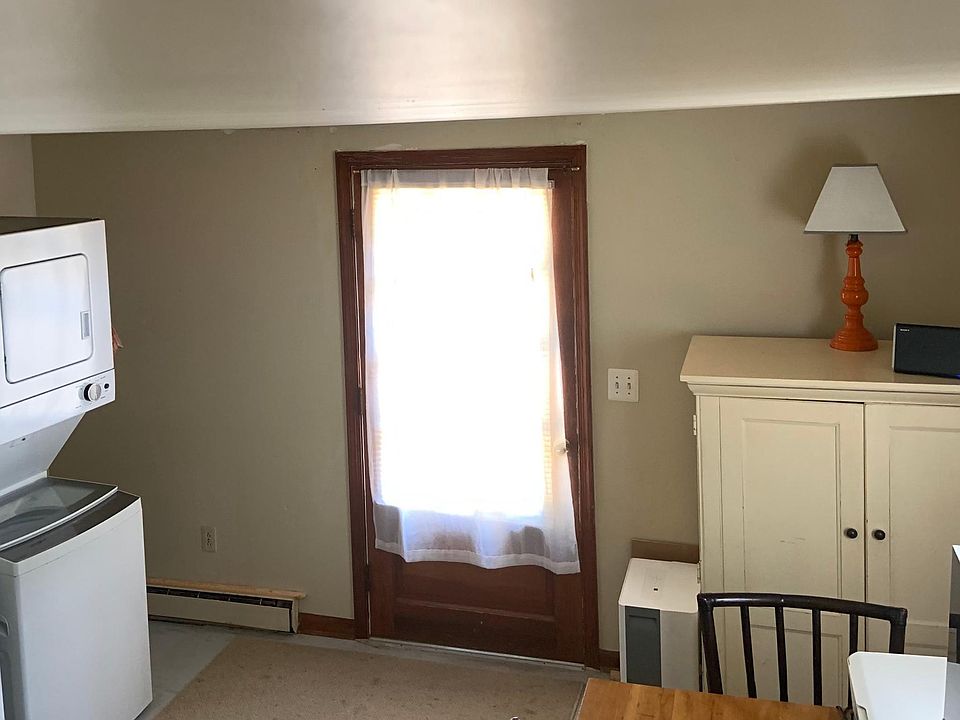 This is the front door, with the seating eating area to the right and the washer/dryer and kitchen wall to the right