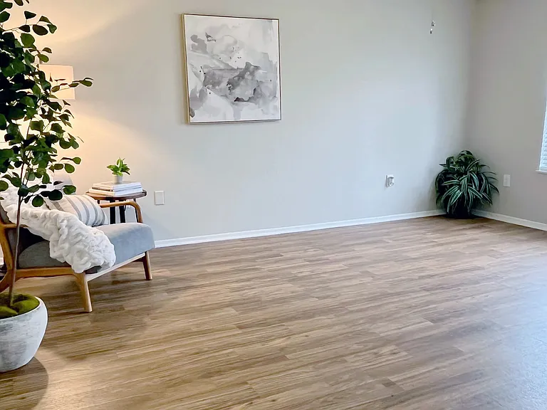 Our generously-sized living rooms with wood-style floors offer the perfect cozy space for relaxation.