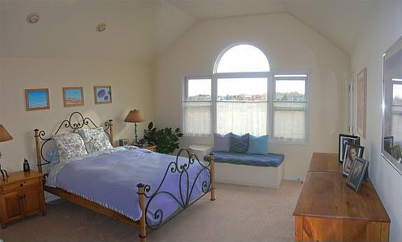 Master bedroom with vaulted ceilings and views