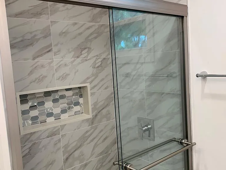 Generous and modern shower with integrated space for bathroom essentials. Lakeland, FL