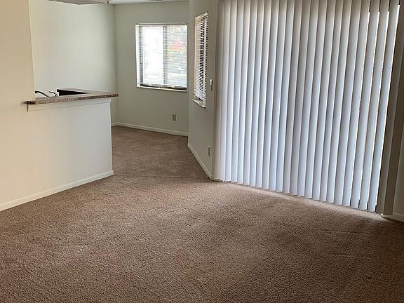 Looking at living room from entry- Fireplace on the right- sliding glass doors to the balcony and dining area