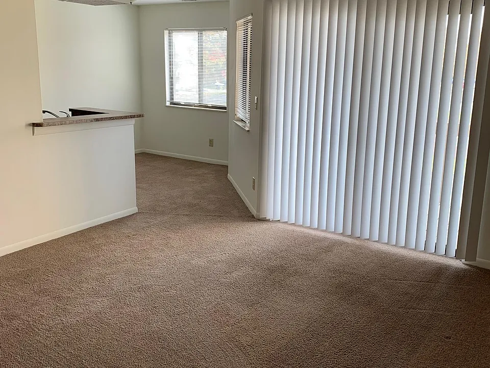 Looking at living room from entry- Fireplace on the right- sliding glass doors to the balcony and dining area