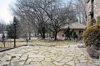Stone patio surrounded by gardens benefiting from a southern exposure