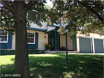 porch shaded by the mature maples