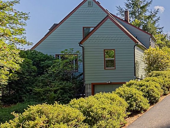 Approaching the house from the driveway, note indoor garage entrance located slightly below the center of the photo