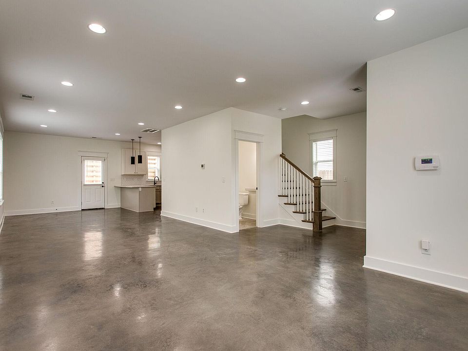 Open floor plan with modern concrete floors.