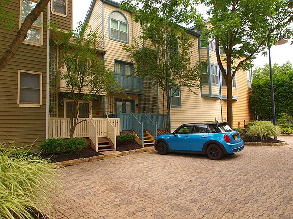 dedicated parking spot off deck (house is tan with blue trim and fence)
