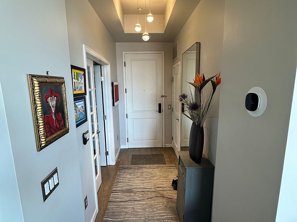 Looking back at front door and short hallway once you enter the apartment. Study/den is on the left.