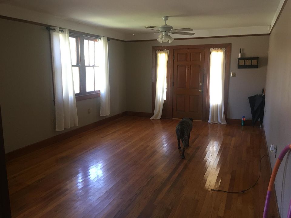 View of front door looking from the formal dining room. Lots of natural light and gleaming hardwood floors in this spacious room.