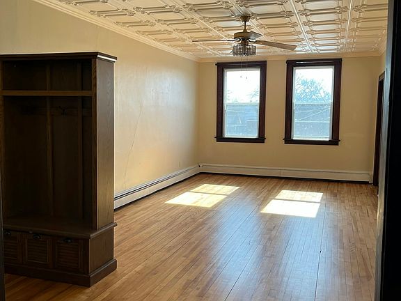Spacious Living Room with ceiling fan and coat tree