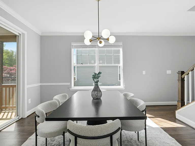 Beautiful dining room opening to kitchen and back porch, perfect for family dinners!