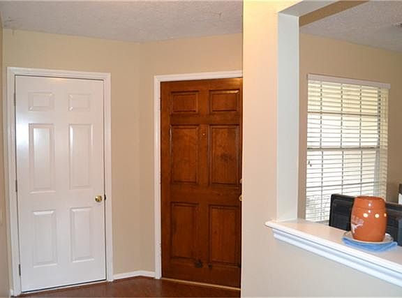 Entry with wood laminate floors.