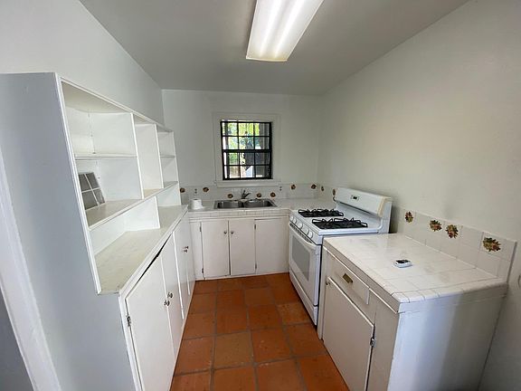 Kitchen with plenty of cabinets & gas range.