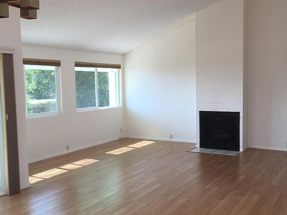 Living room with vaulted ceiling and gas fireplace--is very spacious with the high flat ceilings.