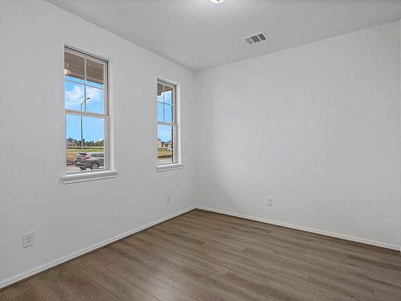 The flex space is perfect for a home office and features beautiful floors and large windows that giv