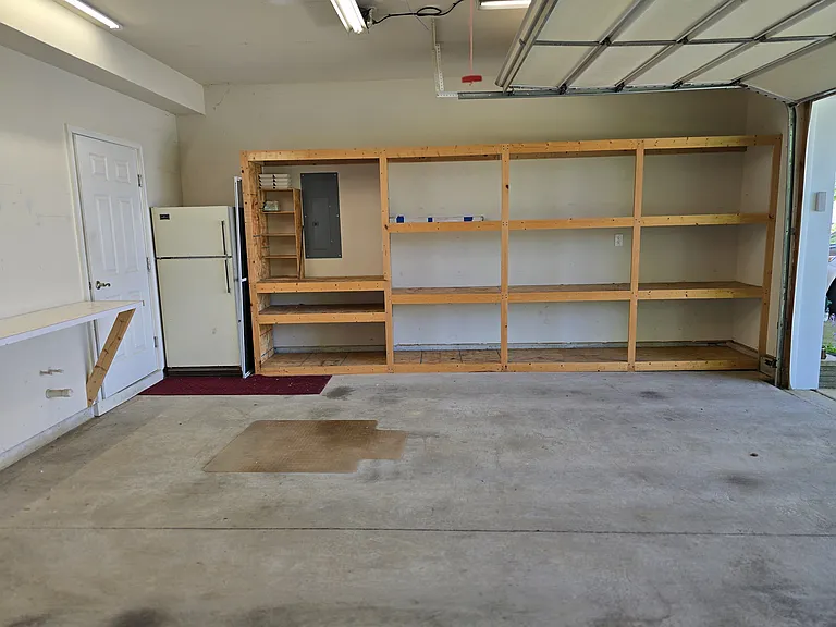 Inside garage. Extra refrigerator available for use by tenants. Storage shelves built in.