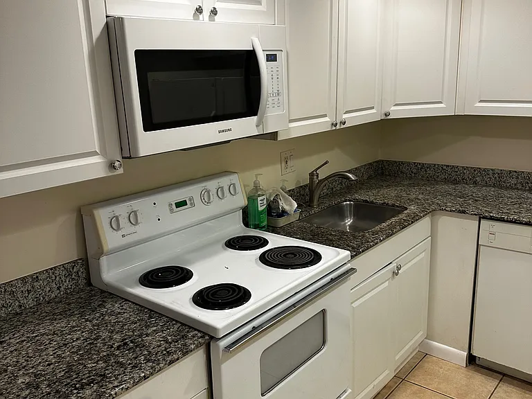 new granite counter top white kitchen cabinets