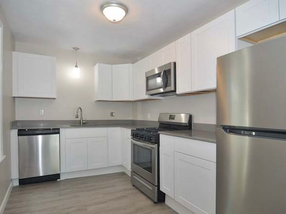 stainless steel, vinyl flooring, sleek design. Small but functional kitchen.