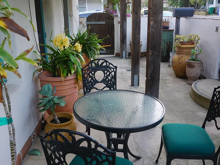 Front Patio detaisl showing table, chairs, pots and plants
