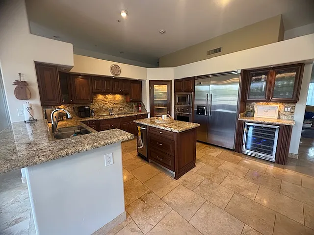 Kitchen with island, and walk-in pantry. Equipped w wine fridge and Viking Profession line appliances: Fridge/freezer, microwave, convection oven, separate warming drawer, 5 burner electric range