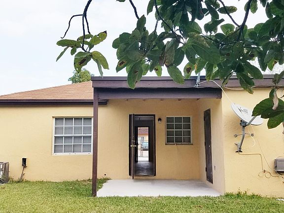 Back patio and separate private laundry room with storage space.