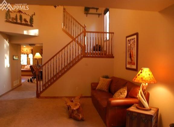 Living room toward stairs and family room, kitchen