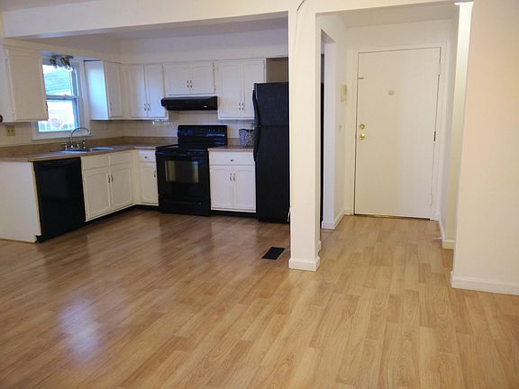 Open concept kitchen/living room/hall way with gleaming hard