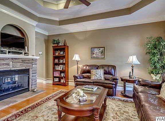 Off the foyer is the living room with step up ceiling with fan, hardwoods and a double sided fireplace!