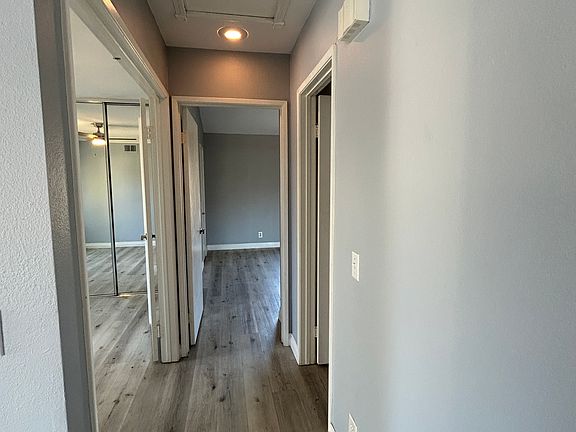 Hallway with attic space for additional lightweight storage. Control for central heating and air conditioning, doorbell, smoke and carbon monoxide detectors.