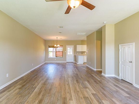 The den leads to the breakfast area and the open kitchen.