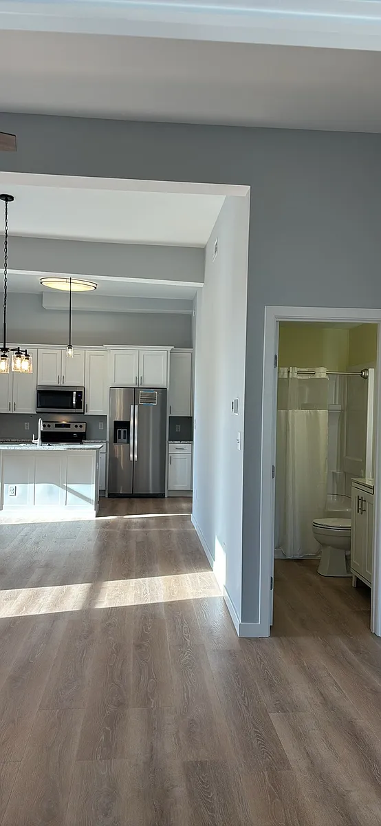 Floors are LVP and this view shows unfurnished apt and location of bathroom and kitchen. - 21 Williams St #2