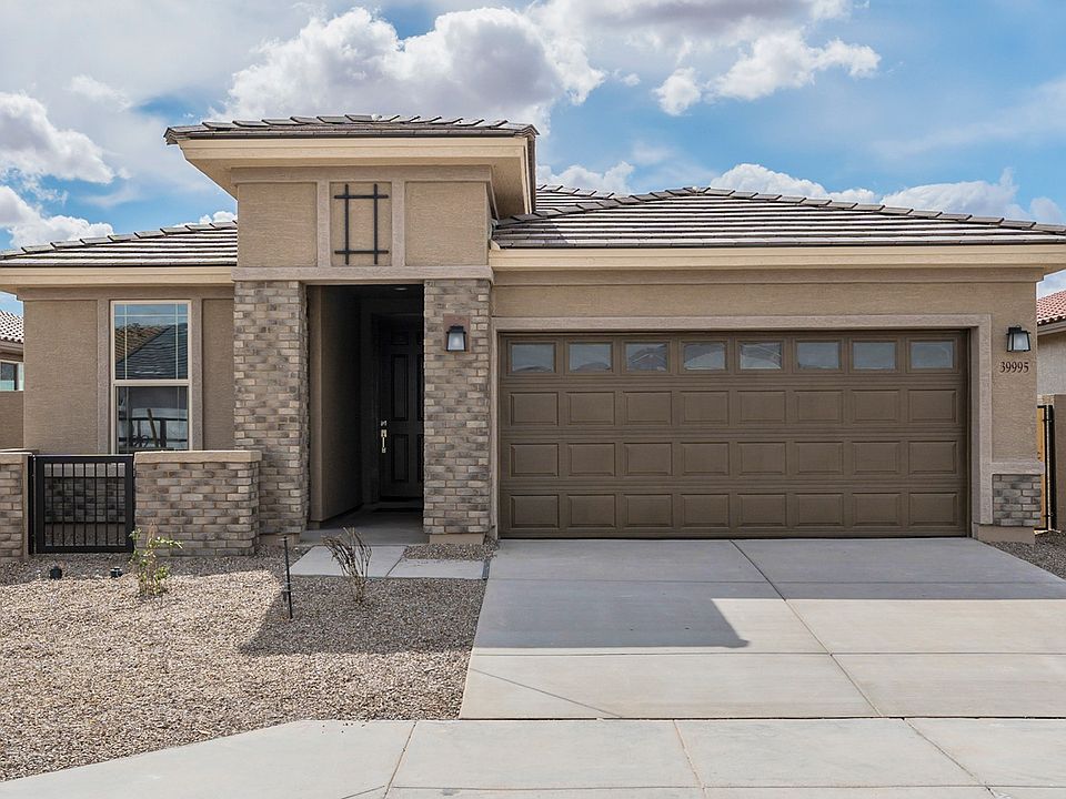 Exquisite Acacia home with elegant brick facade and pristine desert landscaping in Rancho El Dorado.