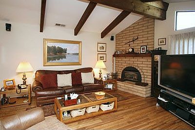 Vaulted ceilings and large fireplace and beautiful hardwood floors